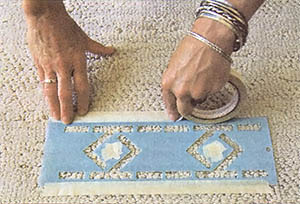 Tape down the entire length of the stencil, not just the corners.